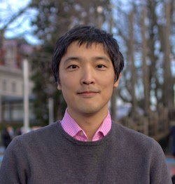 Keita Tamura A photograph of Keita Tamura standing outside, smiling at the camera