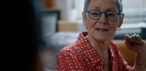 A photo of Prof Christina Holt in conversation with a smile on her face