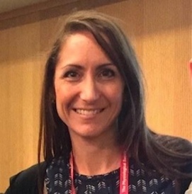 A photograph of Amanda Sferruzzi Perri smiling at the camera