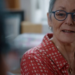A photo of Prof Christina Holt in conversation with a smile on her face